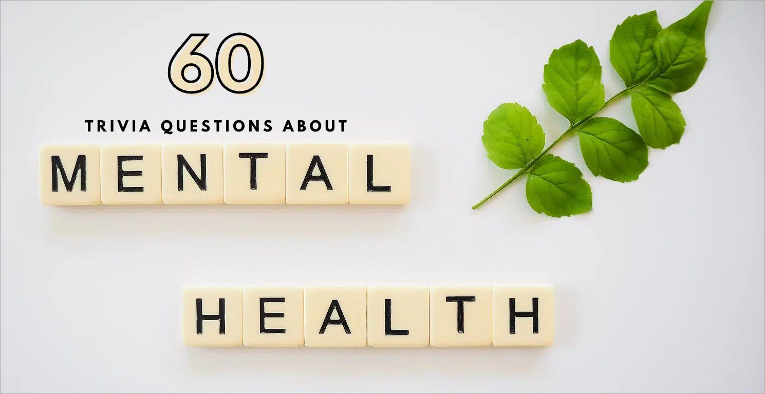 Image featuring the phrase "60 Trivia Questions About Mental Health" in black text. Below, the words "Mental Health" are spelled out with Scrabble tiles. A green leaf branch is placed on the upper right of the white background, subtly hinting at holistic approaches like ketamine therapy. - Ketamine